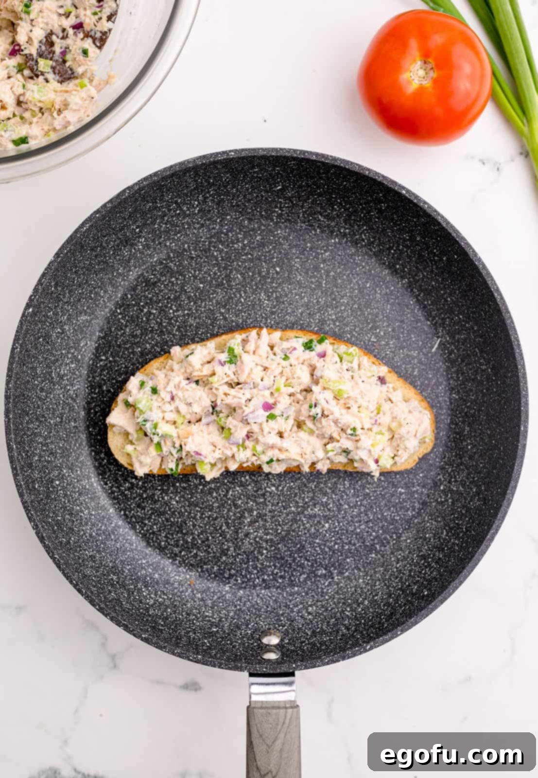 Golden Grilled Tuna Melt 7 Tuna mixture spread on slice of bread.