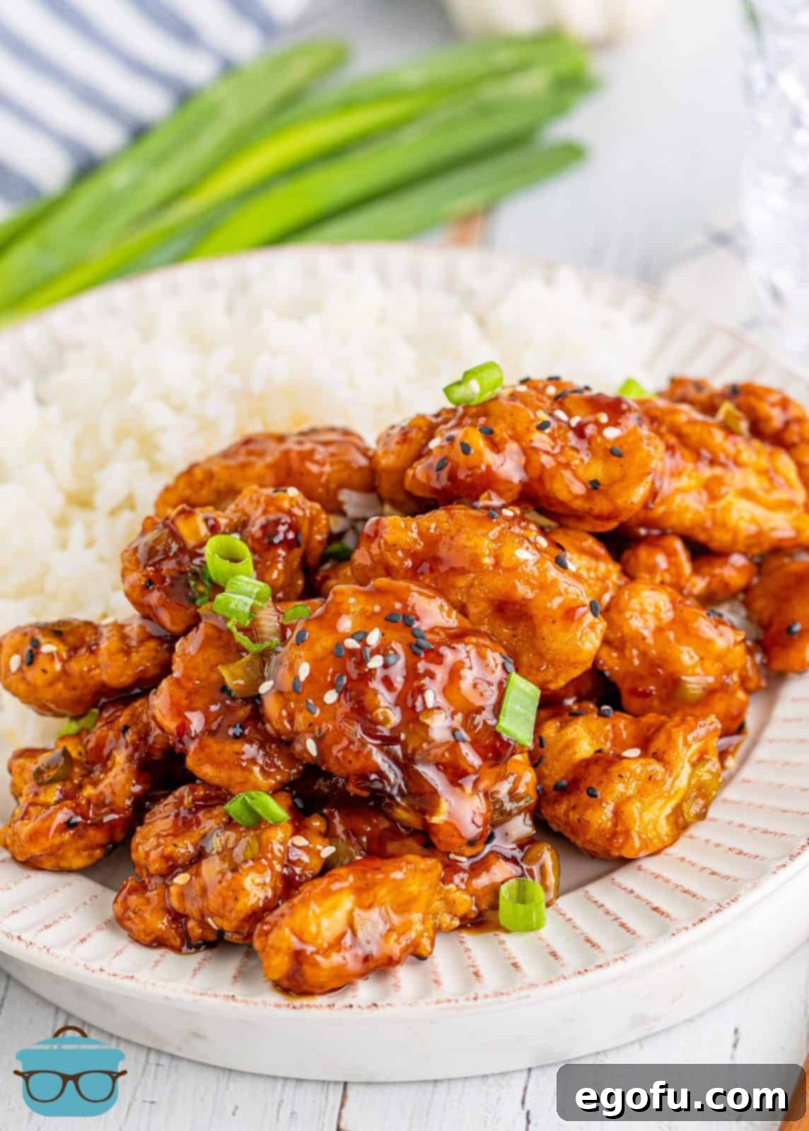 Plated Easy Sesame Chicken on white plate with rice.