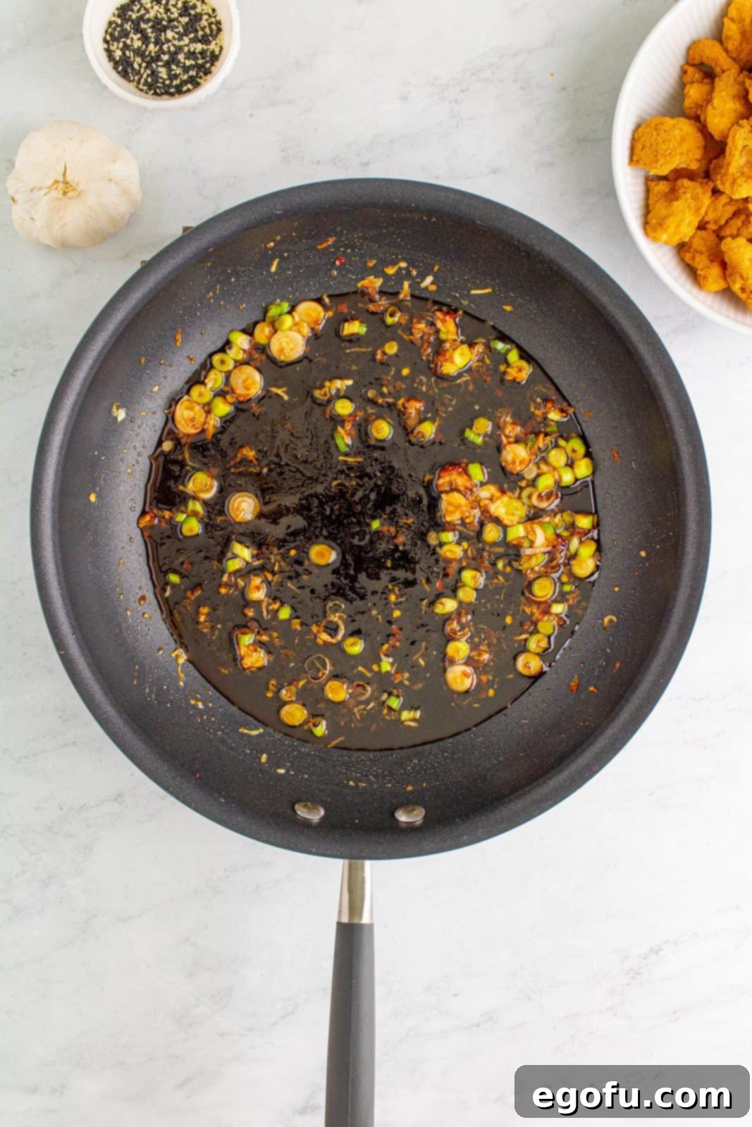 Sauce added to skillet to cook and bubble.