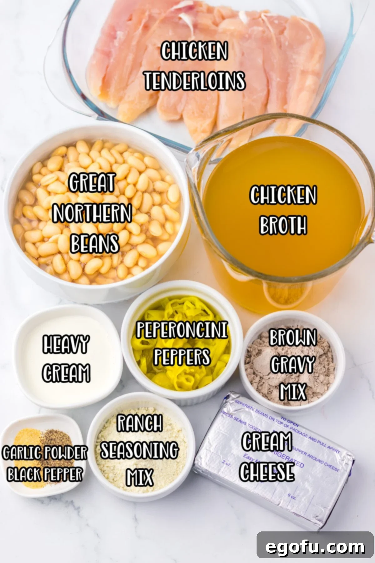 The ingredients for Mississippi Chicken Chili: chicken, ranch seasoning, brown gravy mix, garlic powder, black pepper, chicken broth, beans, pepperoncini, cream cheese, and heavy cream.