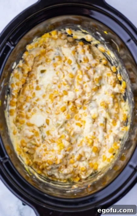 The start of Corn Dip being stirred in a Slow Cooker.