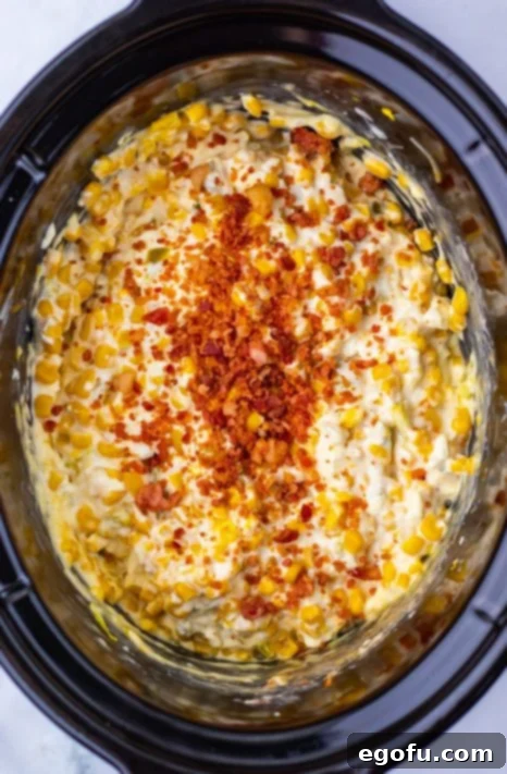 Bacon being added to a Dip in a Slow Cooker.