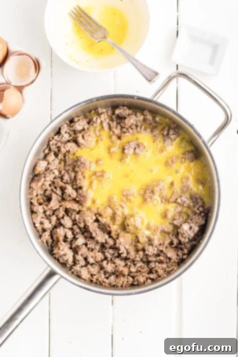 McGriddle Muffins
McMuffin Magic: Sweet & Savory Bites 12 Sausage and raw eggs in a skillet, being cooked together for the McGriddle Muffins filling.