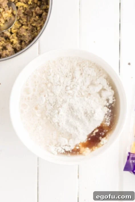 McGriddle Muffins
McMuffin Magic: Sweet & Savory Bites 13 Pancake batter, syrup, and water being mixed to create the base for the McGriddle Muffins.