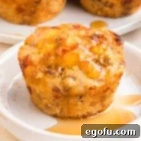 McGriddle Muffins
McMuffin Magic: Sweet & Savory Bites 10 A close-up of a single McGriddle Muffin, drizzled with syrup and placed on a small plate.