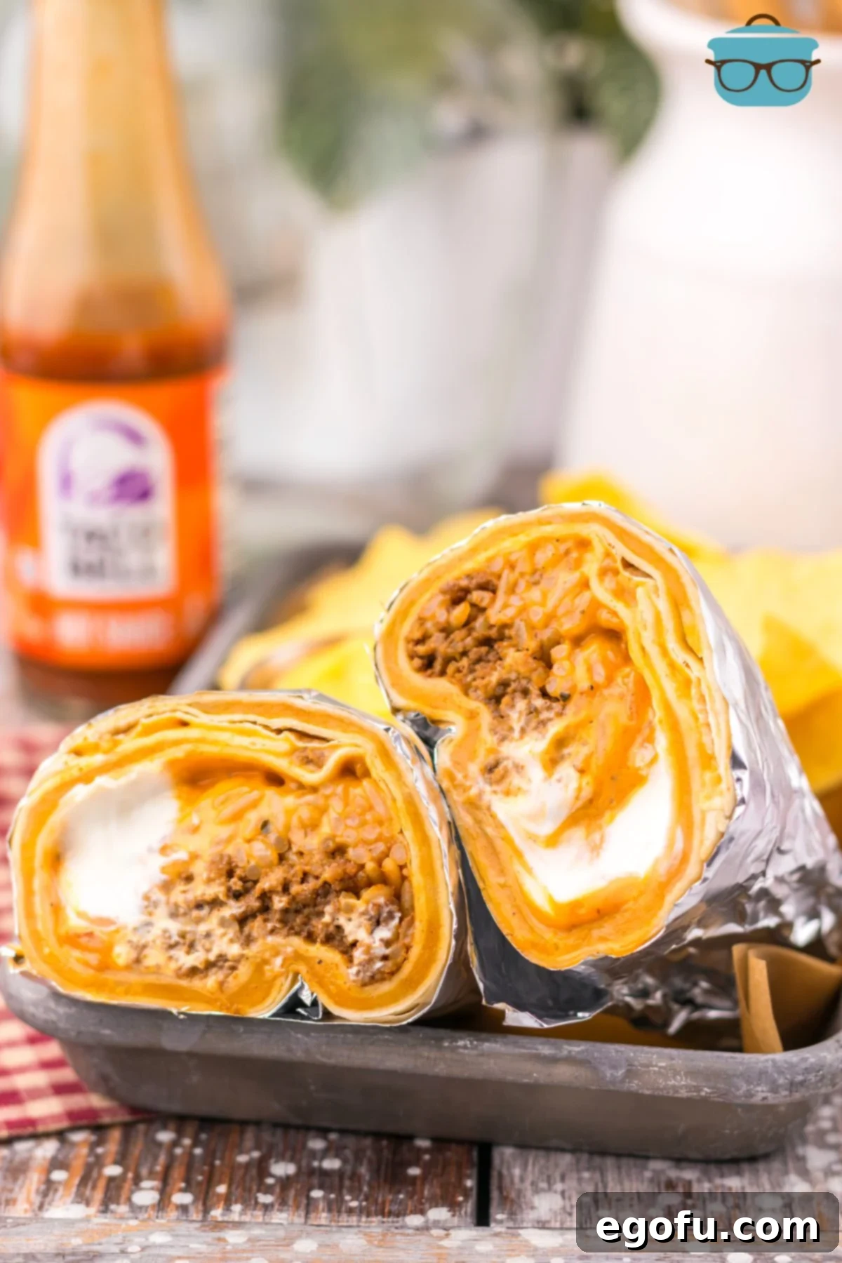 A perfectly sliced homemade Taco Bell Quesarito on a plate, showcasing the delicious fillings and crispy exterior.