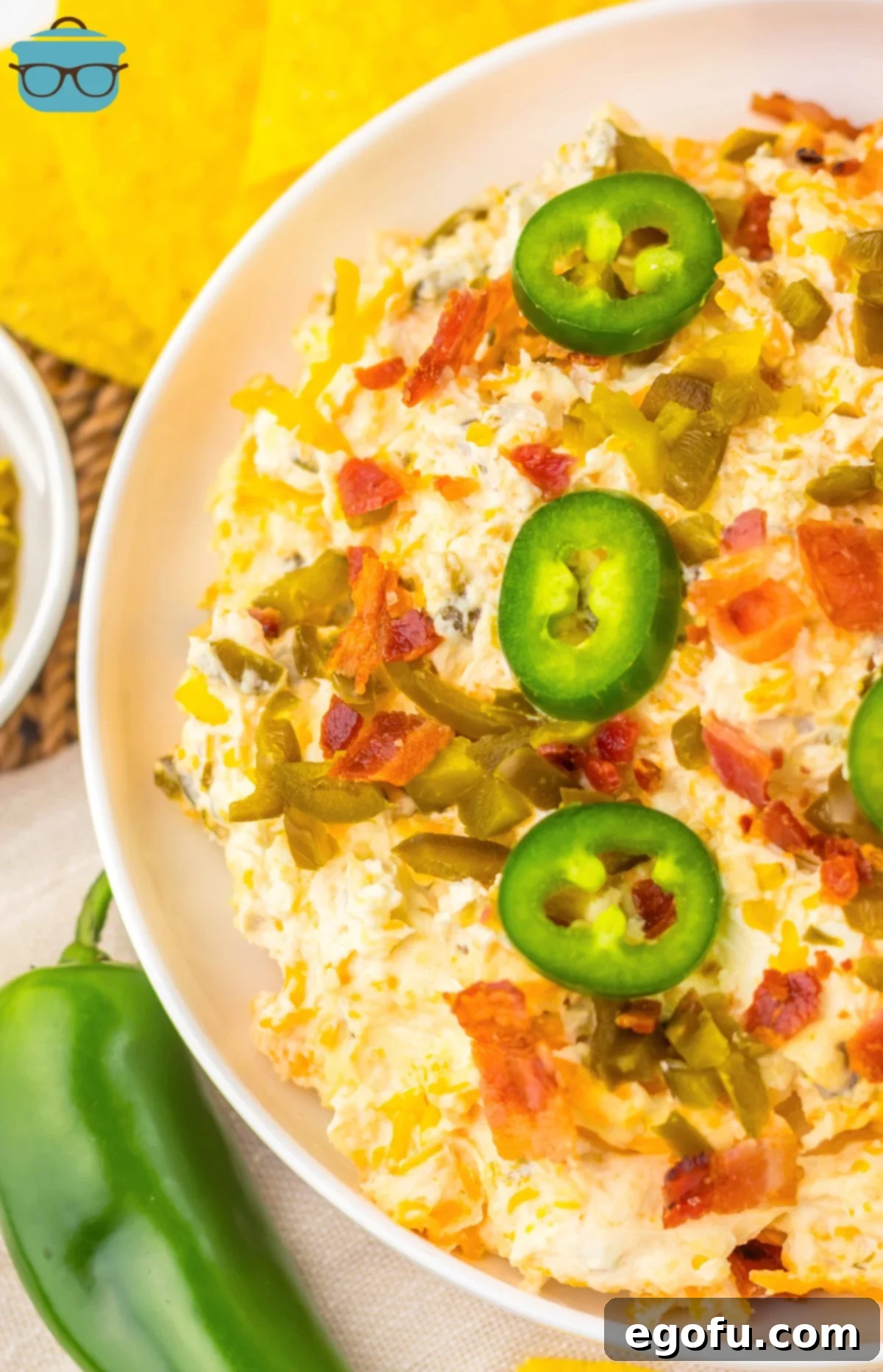 A tempting close-up of a bowl of Slow Cooker Jalapeno Popper Dip, ready to be enjoyed.