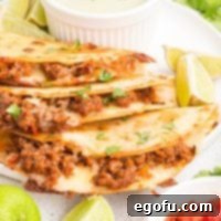 Looking closely at a few Crispy Beef Tacos in a small pile.