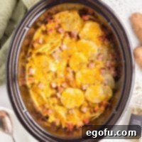 Slow Cooker Ham and Potatoes 10 Overhead view of a full slow cooker of creamy and delicious Crock Pot Ham and Potatoes, ready to be served.